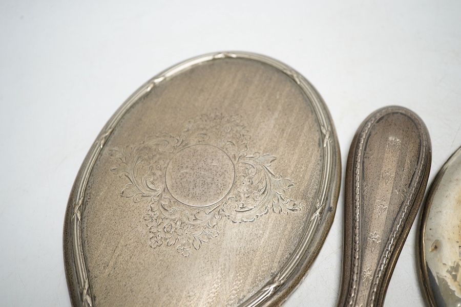 Four assorted silver mounted hand mirrors including London, 1907. Condition - poor to fair